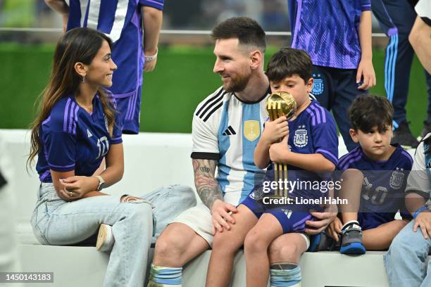 Lionel Messi of Argentina chats with his wife Antonella Roccuzzo after winning the FIFA World Cup Qatar 2022 Final match between Argentina and France...