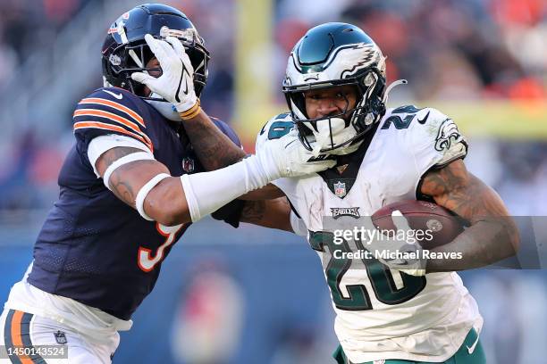 Miles Sanders of the Philadelphia Eagles stiff arms Jaquan Brisker of the Chicago Bears during the second half at Soldier Field on December 18, 2022...