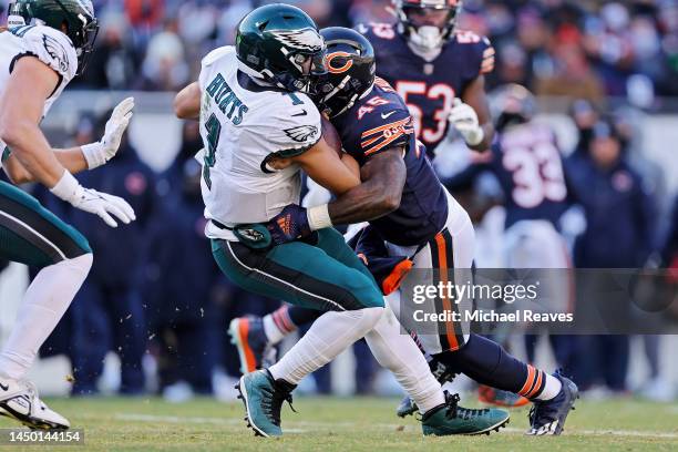 Jalen Hurts of the Philadelphia Eagles is tackled by Joe Thomas of the Chicago Bears during the second half at Soldier Field on December 18, 2022 in...