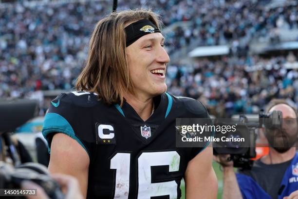 Trevor Lawrence of the Jacksonville Jaguars smiles on the field after defeating the Dallas Cowboys at TIAA Bank Field on December 18, 2022 in...