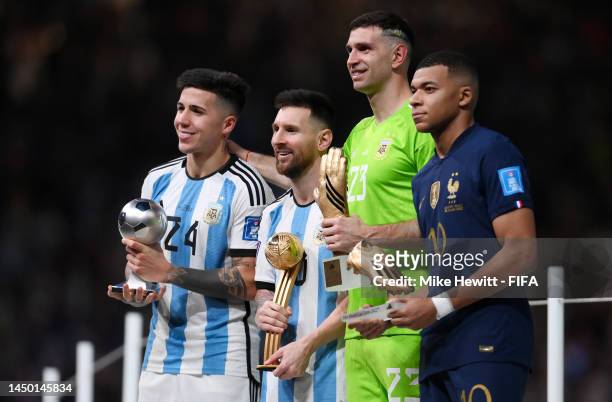 Young Player award winner Enzo Fernandez, adidas Golden Ball winner Lionel Messi, adidas Golden Glove winner Emiliano Martinez of Argentina and...