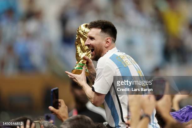 Lionel Messi of Argentina celebrates with the FIFA World Cup Qatar 2022 Winner's Trophy after the team's victory during the FIFA World Cup Qatar 2022...