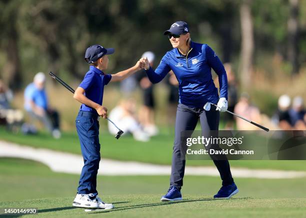 Annika Sorenstam of Sweden fist pumps her son Will McGee as they walk down the 18th hole during the final round of the 2022 PNC Championship at The...