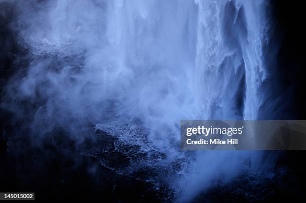 a waterfall at night, iceland - the four elements imagens e fotografias de stock