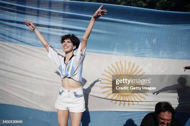 Fan of Argentina celebrates near an Argentinian flag after their team's victory in the final match of the FIFA World Cup Qatar 2022 against France on...