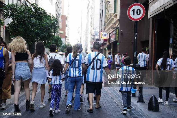 Fans of Argentina wearing the jersey of Lionel Messi walk after the final match of the FIFA World Cup Qatar 2022 against France on December 18, 2022...
