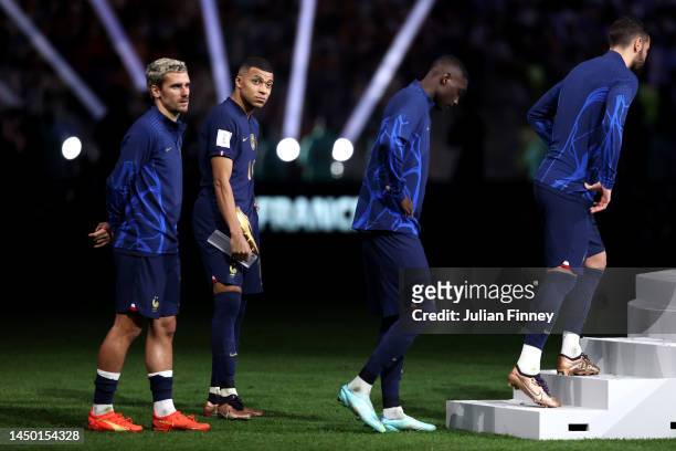 Antoine Griezmann and Kylian Mbappe of France look dejected during the awards ceremony after the FIFA World Cup Qatar 2022 Final match between...
