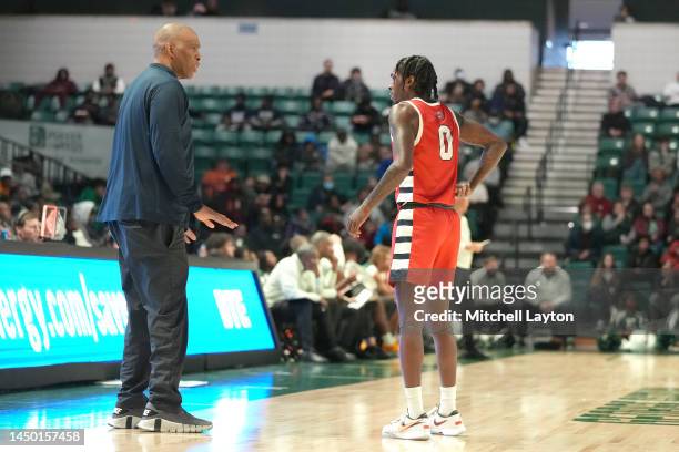 Head coach Mike Davis of the Detroit Mercy Titans talks with his son Antoine Davis during a college basketball game against the Eastern Michigan...
