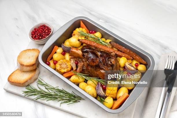 roasted meat pork shank with baked potatoes and corn - winter vegetables stock pictures, royalty-free photos & images