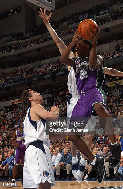 Michael Redd of the Milwaukee Bucks gets trapped underneath the basket attempting a pass against the Dallas Mavericks at the American Airlines Center...