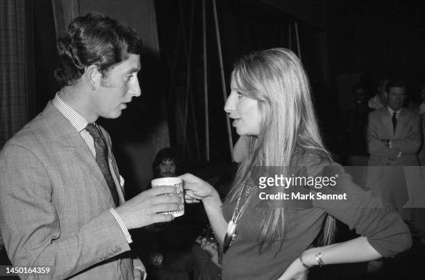 Prince Charles and singer Barbra Streisand share a moment over coffee at Warner Bros. Studio on March 19, 1974 in Los Angeles, California.