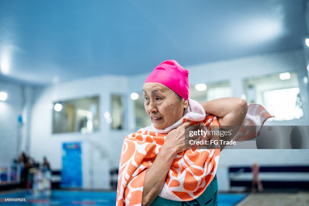 Senior woman towel drying herself after swimming class