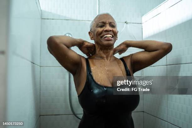 senior woman taking a shower after swimming class - running water bath stock pictures, royalty-free photos & images