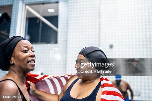 Women Talking While Towel Drying After Swimming Class High Res Stock women-talking-while-towel-drying-after-swimming-class-high-res-stock
