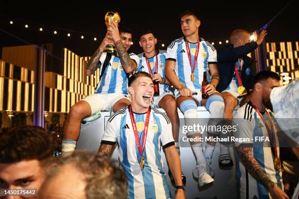 Exequiel Palacios, Nahuel Molina Paulo Dybala and Lisandro Martinez of Argentina celebrate after winning the FIFA World Cup on an open top bus...