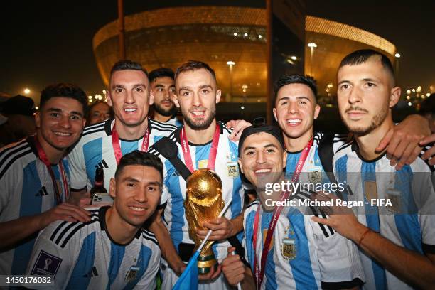 German Pezzella of Argentina celebrates with teammates after winning the FIFA World Cup on an open top bus outside the stadium during the FIFA World...