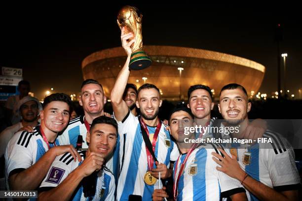 German Pezzella of Argentina celebrates with teammates after winning the FIFA World Cup on an open top bus outside the stadium during the FIFA World...