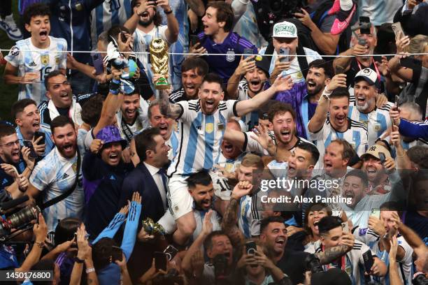 Lionel Messi of Argentina celebrates with the world cup trophy following his sides victory during the FIFA World Cup Qatar 2022 Final match between...