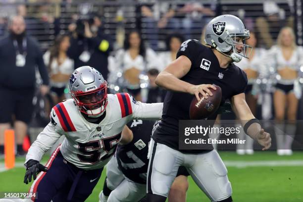 Quarterback Derek Carr of the Las Vegas Raiders is chased by linebacker Josh Uche of the New England Patriots in front of offensive tackle Kolton...