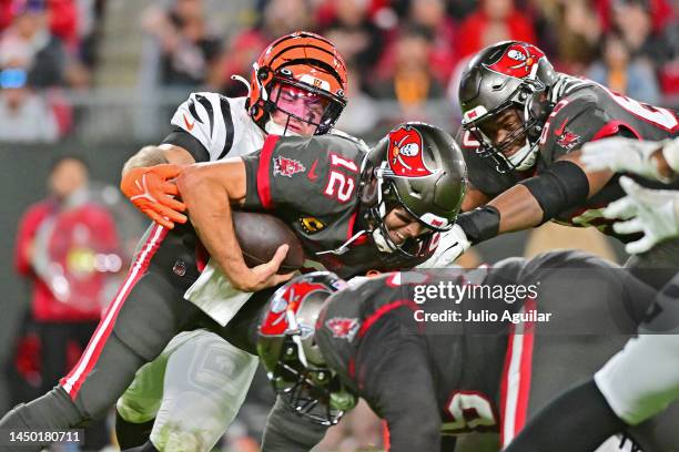 Logan Wilson of the Cincinnati Bengals forces a fumble by Tom Brady of the Tampa Bay Buccaneers during the third quarter at Raymond James Stadium on...