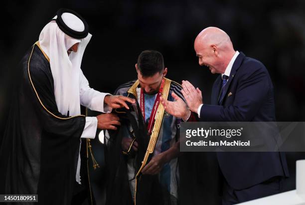 Lionel Messi of Argentina is presented a traditional black bisht robe by Sheikh Tamim bin Hamad Al Thani, Emir of Qatar, while Gianni Infantino,...