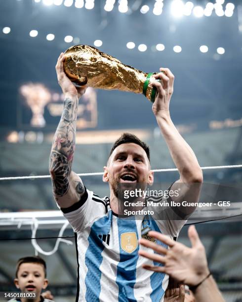 Lionel Messi of Argentina celebrates victory with the trophy after the FIFA World Cup Qatar 2022 Final match between Argentina and France at Lusail...