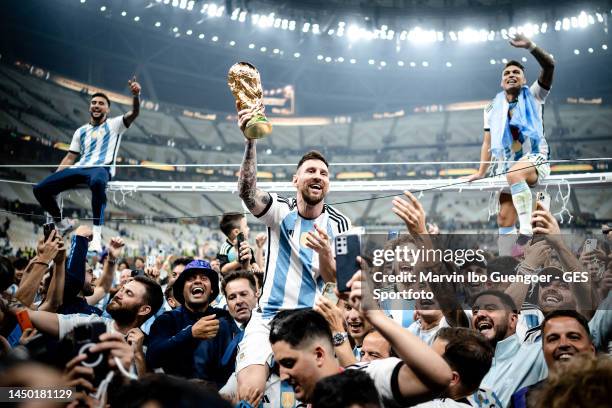 Lionel Messi of Argentina celebrates victory with the trophy after the FIFA World Cup Qatar 2022 Final match between Argentina and France at Lusail...