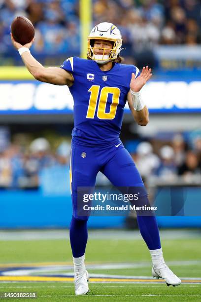 Justin Herbert of the Los Angeles Chargers throws a pass against the Tennessee Titans during the second half at SoFi Stadium on December 18, 2022 in...