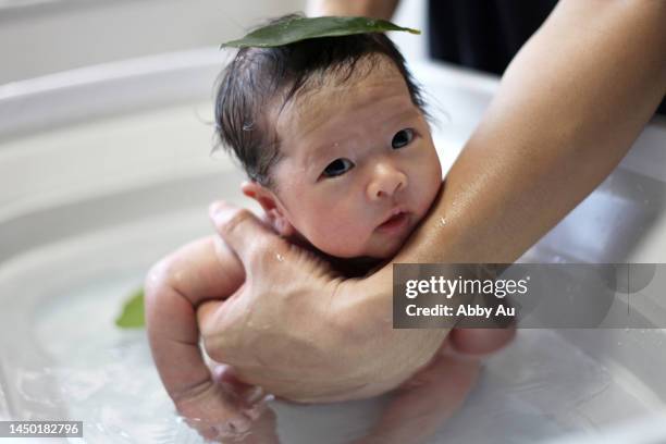 high angle view of cute baby girl taking a bath - washing tub stockfoto's en -beelden