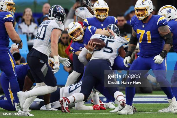 DeMarcus Walker of the Tennessee Titans sacks Justin Herbert of the Los Angeles Chargers during the third quarter of the game at SoFi Stadium on...