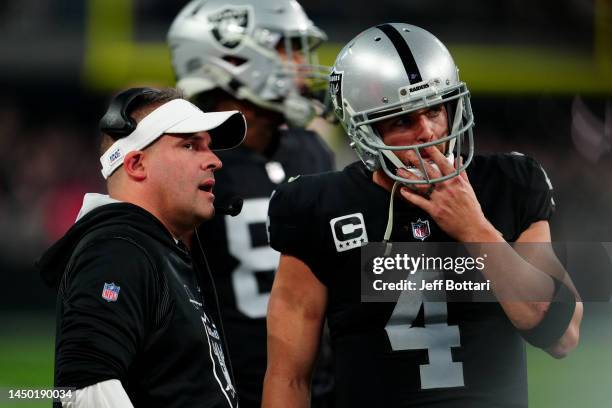 Head coach Josh McDaniels of the Las Vegas Raiders and Derek Carr react during the second half against the New England Patriots at Allegiant Stadium...