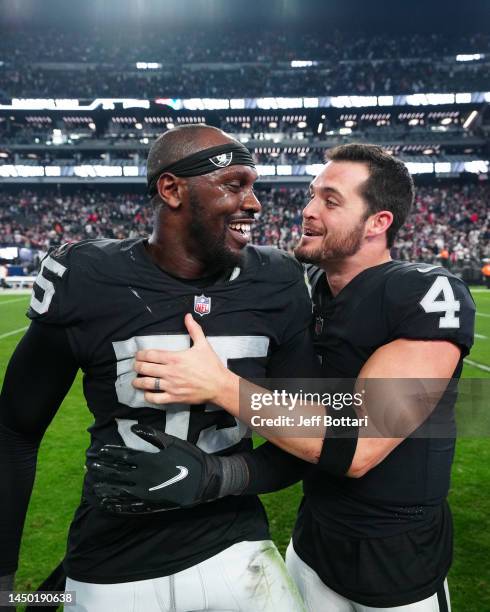 Chandler Jones and Derek Carr of the Las Vegas Raiders celebrate after defeating the New England Patriots at Allegiant Stadium on December 18, 2022...