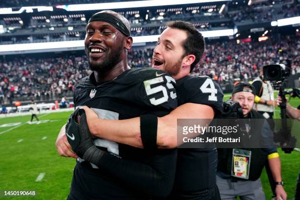 Chandler Jones and Derek Carr of the Las Vegas Raiders celebrate after defeating the New England Patriots at Allegiant Stadium on December 18, 2022...