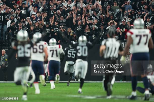 Fans cheer as Chandler Jones of the Las Vegas Raiders scores a touchdown to defeat the New England Patriots at Allegiant Stadium on December 18, 2022...