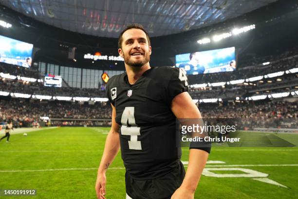 Derek Carr of the Las Vegas Raiders celebrates on the field after defeating the New England Patriots at Allegiant Stadium on December 18, 2022 in Las...
