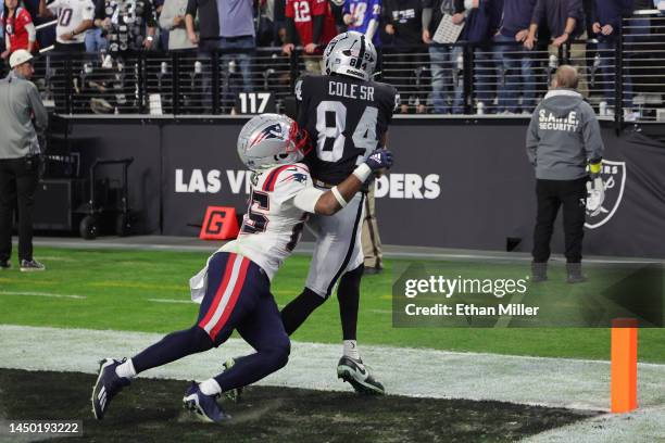 Keelan Cole of the Las Vegas Raiders catches the ball for a touchdown as Marcus Jones of the New England Patriots defends during the fourth quarter...