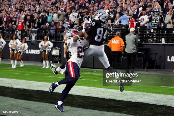 Keelan Cole of the Las Vegas Raiders catches the ball for a touchdown as Marcus Jones of the New England Patriots defends during the fourth quarter...