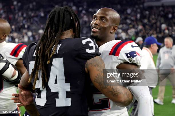 Devin McCourty of the New England Patriots and Brandon Bolden of the Las Vegas Raiders talk after a game at Allegiant Stadium on December 18, 2022 in...