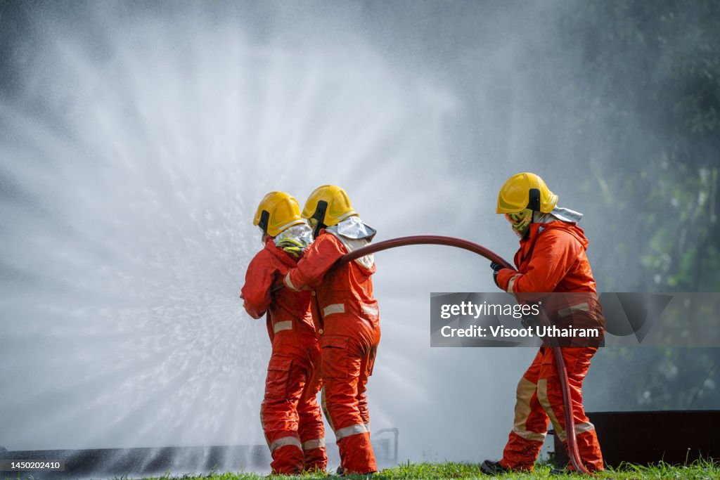 Firefighters Using A Rook Firefighter Training Fireman Using Water And Extinguisher To Fighting ...