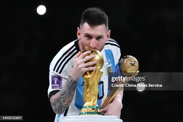 Adidas Golden Ball winner Lionel Messi of Argentina kisses the FIFA World Cup Winner's Trophy at the award ceremony following the FIFA World Cup...