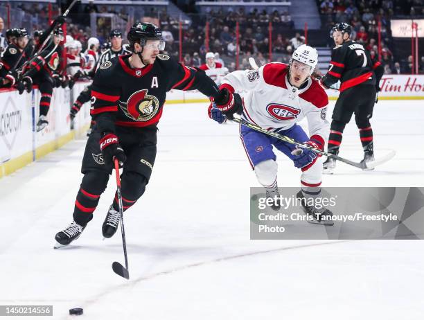 Thomas Chabot of the Ottawa Senators and Michael Pezzetta of the Montreal Canadiens race for the puck at Canadian Tire Centre on December 14, 2022 in...