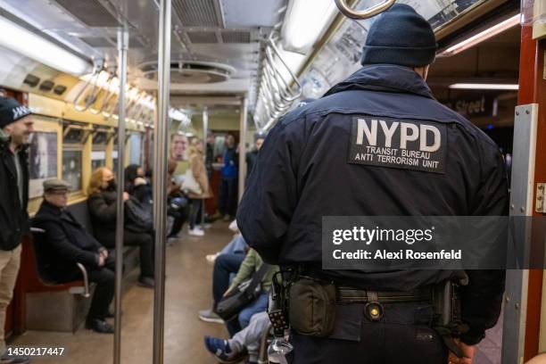 Member of the NYPD Transit Bureau's Anti Terrorism unit rides the Holiday Nostalgia train on the final day of service on December 18, 2022 in New...
