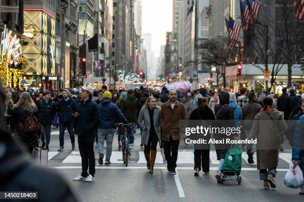 People walk along Fifth Avenue during the Open Streets program during its last day on December 18, 2022 in New York City. The Fifth Avenue...