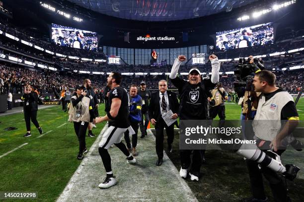 Derek Carr of the Las Vegas Raiders and head coach Josh McDaniels of the Las Vegas Raiders celebrate after defeating the New England Patriots during...