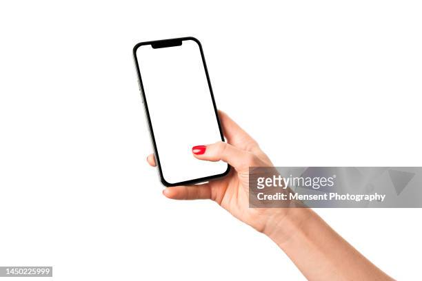 womans hand holding modern mobile phone iphone mockup with white screen on white background - telefon stock-fotos und bilder