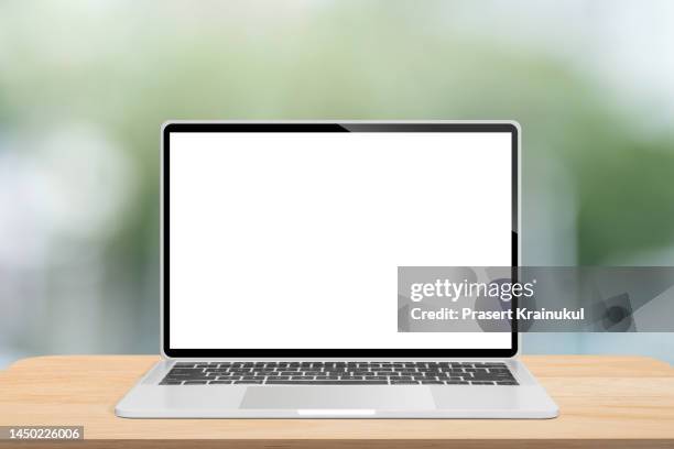 laptop with blank screen on wood table - wood desk ストックフォトと画像