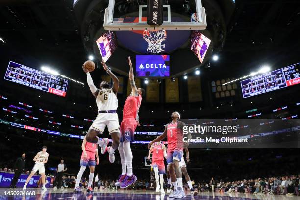 LeBron James of the Los Angeles Lakers drives to the basket defended by Kyle Kuzma of the Washington Wizards in the second half at Crypto.com Arena...
