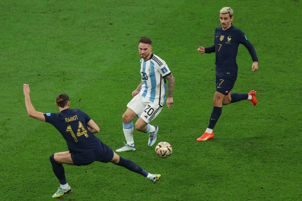 Alexis Mac Allister of Argentina controls the ball against Adrien Rabiot of France during the FIFA World Cup Qatar 2022 Final match between Argentina...