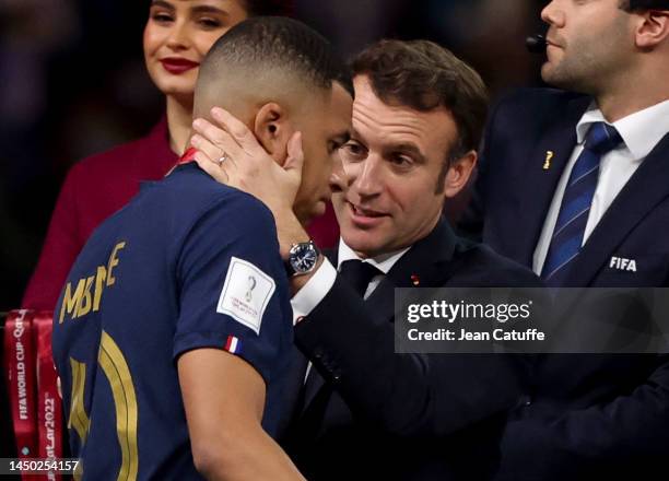 Kylian Mbappe of France is consoled by President of France Emmanuel Macron during the trophy ceremony following the FIFA World Cup Qatar 2022 Final...