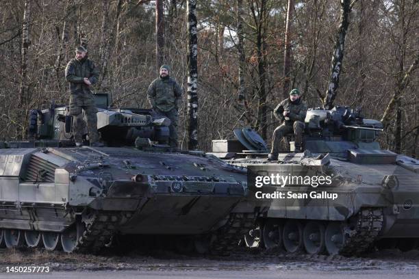 Puma and Marder infantry fighting vehicles of the Bundeswehr, the German armed forces, drives in a snow storm at a military training ground on...